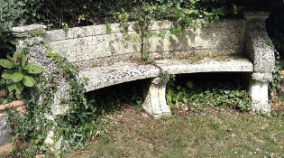 A reconstituted stone garden exedra seat,   20th century, the curved and panel moulded backrest and