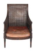 A Regency mahogany bergere library chair , circa 1815, the scrolled curved top rail and arms with