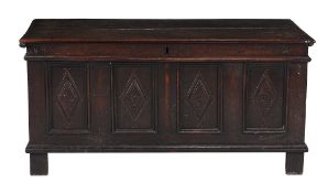 A panelled oak chest  , mid 17th century, the hinged lid above a quadruple panelled and lozenge