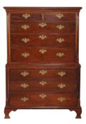 A George III walnut chest on chest, circa 1780, the moulded cornice above chest of two short and