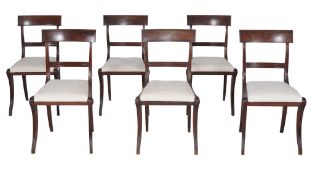 A set of six Regency mahogany dining chairs,   circa 1815, each string inlaid bar back above
