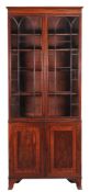 A Regency mahogany bookcase , circa 1815, the moulded cornice above a pair of arch moulded glazed