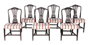 A set of six George III mahogany dining chairs  , circa 1780, each with a curved top rail with