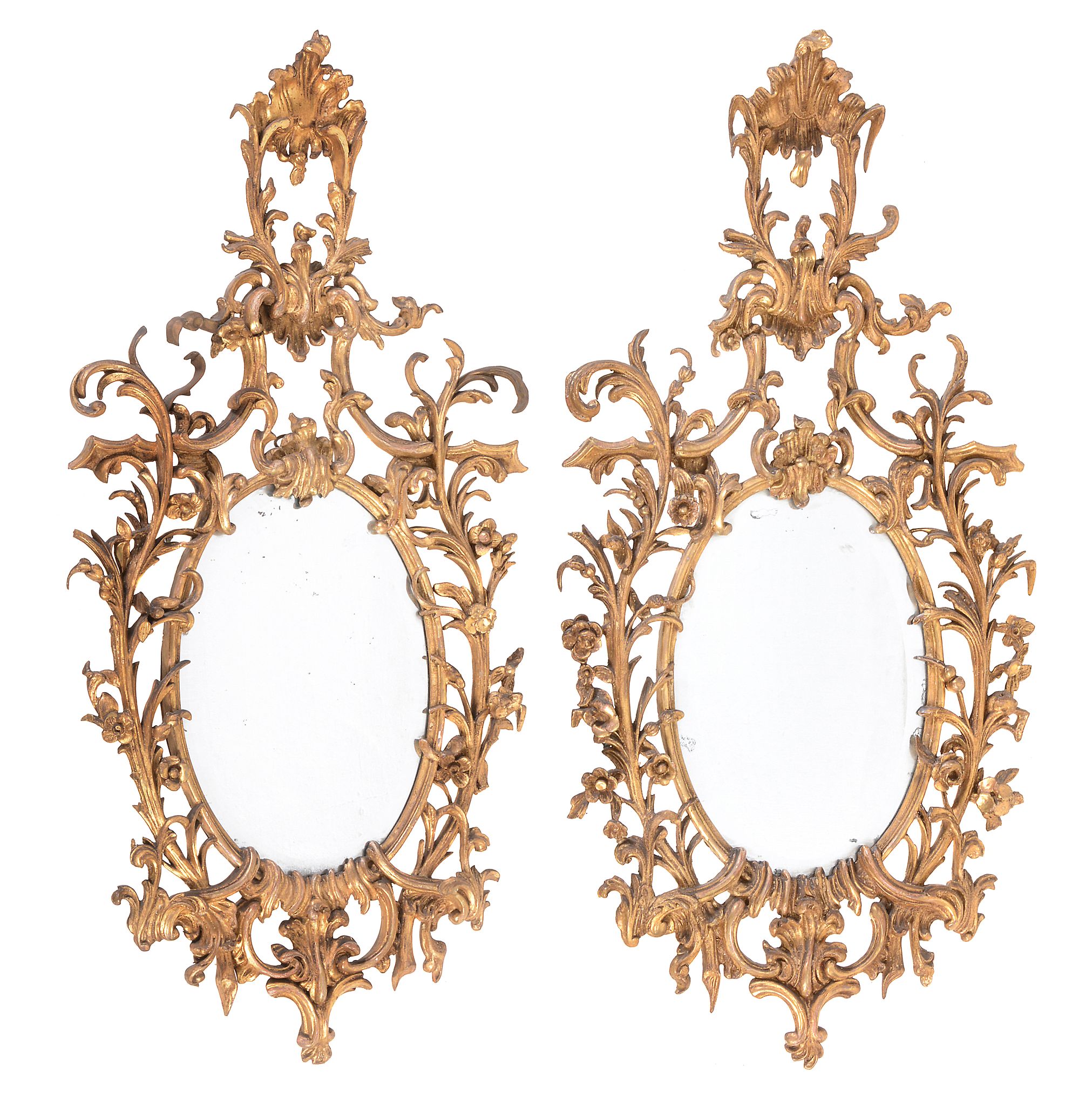 A pair of giltwood oval wall mirrors in George III style  , 19th century, each with raised surmount