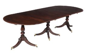 A mahogany triple pillar dining table,   in George IV  style, late 19th century,  the reeded and