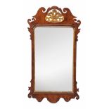 A George II mahogany and parcel gilt fretwork wall mirror,   circa 1740, the rectangular mirror-