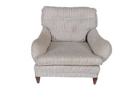 A Victorian upholstered armchair in the manner of Howard  &  Sons  , circa 1890, with loose cushion