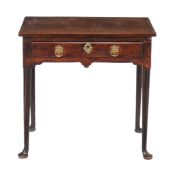 A George II walnut side table  , circa 1740, the line inlaid rectangular top above a single frieze