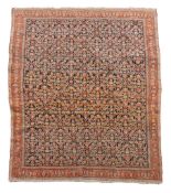 A Senneh rug  , the dark blue field woven with an intricate lattice of stylised flowers withing a
