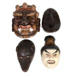 A collection of approximately thirty facial masks  , including African and Asian examples, 20th