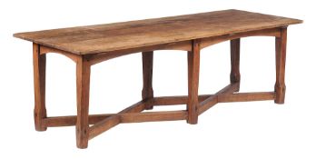 An oak Arts  &  Crafts refectory table  , circa 1890, the plank top above arched apron rails and