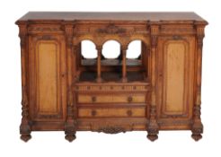 A Victorian satinwood side cabinet  , circa 1870, of breakfront outline, the top with leaf carved
