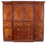 A George III  secretaire  compactum wardrobe,   circa 1800, of breakfront outline, the moulded