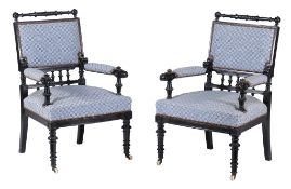 A pair of late Victorian ebonised open armchairs  , circa 1890, each with turned and twist toprail