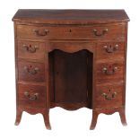 A George III mahogany bowfront kneehole desk  , circa 1790, the arrangement of seven drawers around