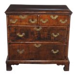 A walnut chest of drawers  , first quarter 18th century and later, the crossbanded rectangular top