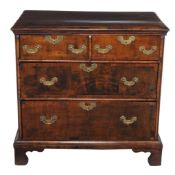 A walnut chest of drawers  , first quarter 18th century and later, the crossbanded rectangular top