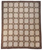 An English wool needlework and petit point rug,   worked 56 rectangular floral panels within ribbon