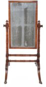 A George IV mahogany cheval mirror  , circa 1825, the rectangular mirror plate within cushion frame