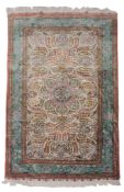 A Persian silk rug, 20th century, with turquoise border, together with another Persian silk rug,