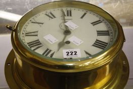 A brass ships clock,   the dial with Roman numerals and subsidiary seconds dial, 26cm