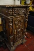 A 19th Century German pedestal cabinet   with lions and female figures 126cm high, 65cm wide