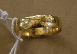 An 18ct gold wedding band,   3.6g approx.