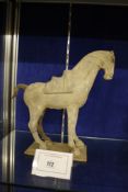 A Chinese pottery model of a saddled standing horse  , possibly Tang dynasty, 32cm high