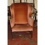 An upholstered wing armchair