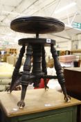 A Victorian adjustable piano stool   bearing stamp to underside ?????? on turned legs with claw
