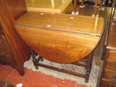 A mahogany oval top gateleg table   on turned supports 90cm wide
