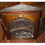 A Georgian style mahogany corner cupboard  , the arched glazed door enclosing two shelves 70cm wide