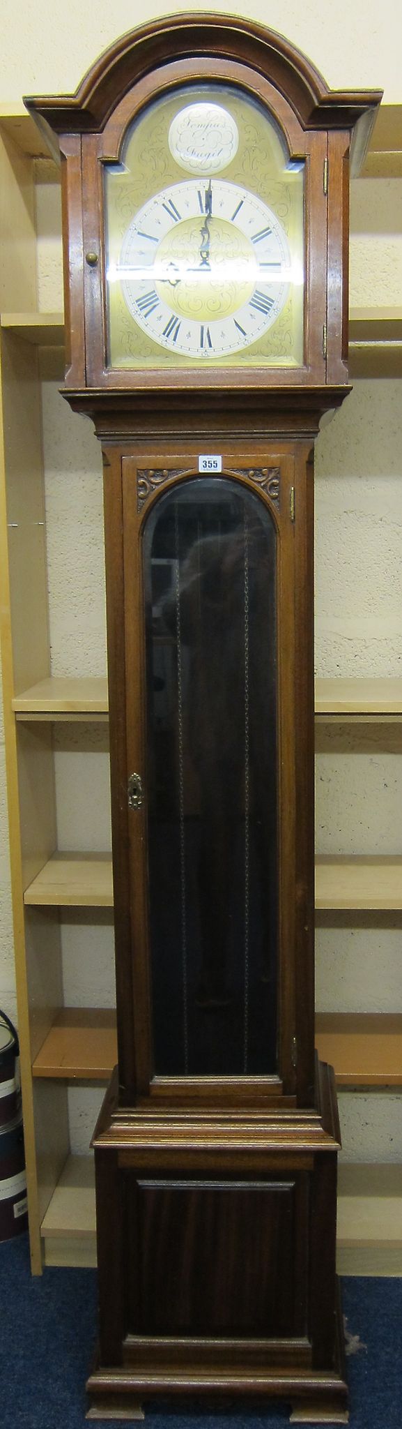 A mahogany longcase clock   with an arched brass and silvered dial, with Roman and numeral numbers,
