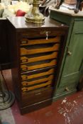An early 20th Century oak filing cabinet   with tambour front