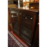 A mahogany bookcase  , the pair of glazed panel doors enclosing three adjustable shelves on bracket