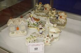 A Staffordshire pottery cottage moneybox,   two miniature Staffordshire cottages, a pair of spill