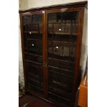 A glazed mahogany bookcase  , with astragal glazing enclosing adjustable shelves, on bracket feet