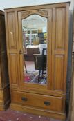 An Edwardian walnut wardrobe   with a mirrored door and drawer to the base.198cm x 110cm.