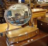 A George III mahogany bowfront dressing table mirror  , circa 1815, oval mirror plate, three