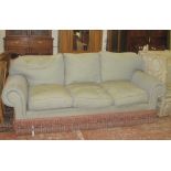 A large three-seat sofa green upholstered/red spots,   a pink upholstered footstool, and a pair of