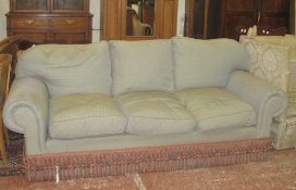 A large three-seat sofa green upholstered/red spots,   a pink upholstered footstool, and a pair of