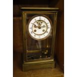 A French 19th Century glass and brass mantel clock,   Roman numeral enamel dial, 28cm x 16cm
