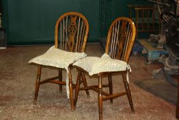 A pale green painted dining table (plus three leaves) and a set of four Windsor chairs, 20th