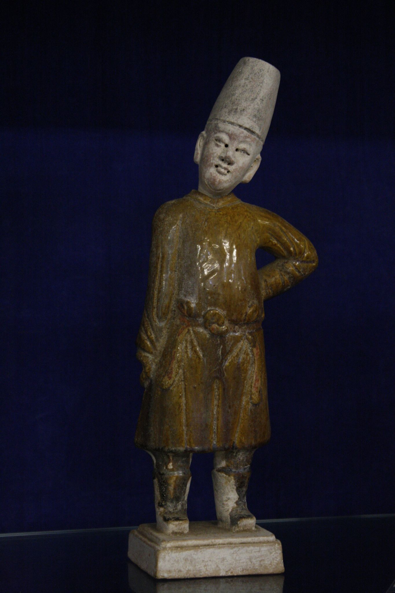 A Chinese pottery funerary figure   of a standing man 32cm high