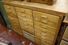 An oak filing cabinet   with three banks of short drawers 117cm wide