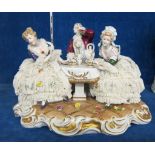 A German porcelain figure group  , drinking tea, marked Unter Weiss Bach to base, 31cm wide approx;