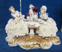 A German porcelain figure group  , drinking tea, marked Unter Weiss Bach to base, 31cm wide approx;