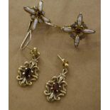 A pair of silver drop earrings  , with central garnet surround by opals and seed pearls and another