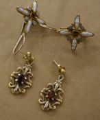A pair of silver drop earrings  , with central garnet surround by opals and seed pearls and another