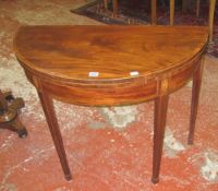 A late George III mahogany and cross banded demi-lune card table   on tapered square legs, 89cm
